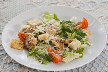 Meat salad with vegetables and croutons.