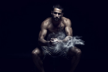 Muscular handsome man in Studio with flour