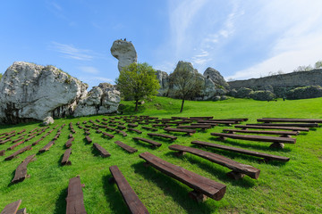 Benches on green lawn at Ogrodzieniec castle in spring, Poland