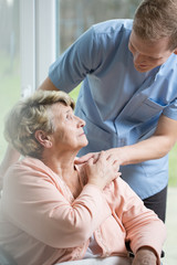Male nurse caring about ill woman