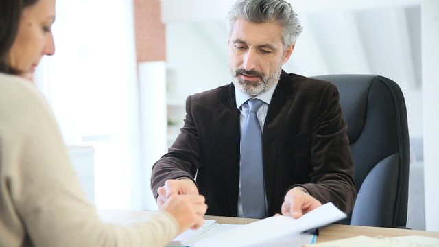 Attorney and client meeting in office for signature