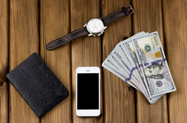 Business concept. Passport, dollars, watch, phone