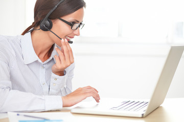 Cheerful receptionist conversing on her headset