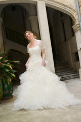 Obraz premium Beautiful young happy bride in a white and ivory wedding dress