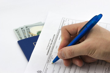 Passport, dollars, blank of visa application