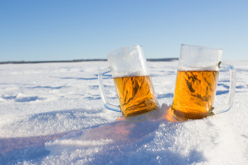 Two mugs of cold beer