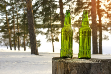 Two bottles of cold beer at sunset