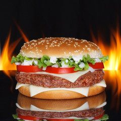 Hamburger on black background with refletion and real fire