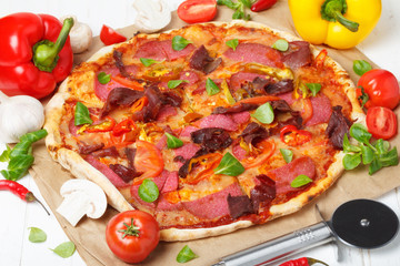 Traditional home made pizza with ham and salami