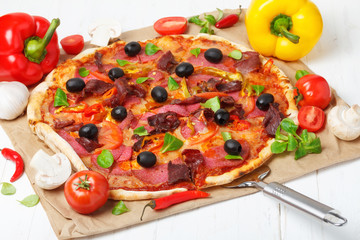 Classic traditional home made pizza with ham and salami