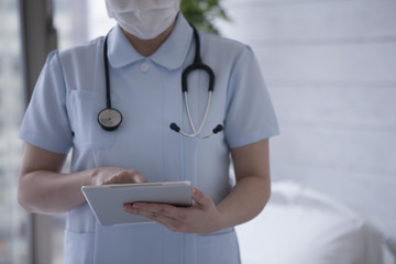 Nurse looking at the electronic tablet
