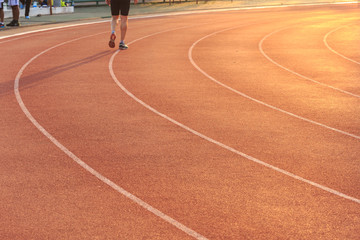 Fototapeta premium Running track with blur of runner feet in stadium