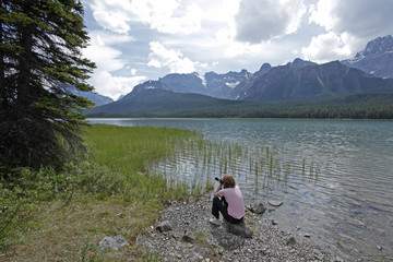 Tourist photographing Lake Louise in Banff National Park
