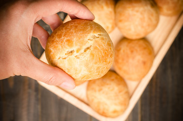 Homemade bun is holding by hand