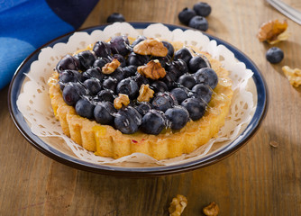 Tasty tart with blueberries  on a wooden table