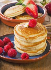 pancakes with berries and  butter .