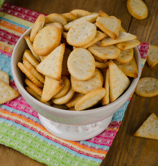 Crackers in white bowl on  a wooden background