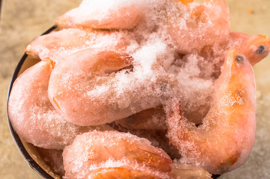 Frozen shrimp in ice and snow poured