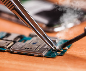 repair a broken mobile phone closeup