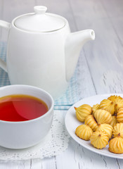 A cup of redbush tea with tiny shortbread cookies