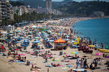 People and sun umbrellas on the beach