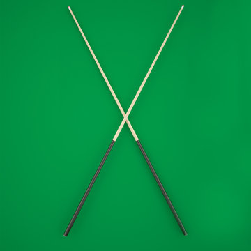 Crossed cue on a green billiard table