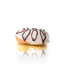 Donut coated with white glaze and chocolate