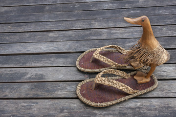 Wooden duck on sandals