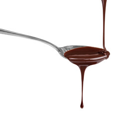 Hot chocolate stream flows on a spoon on a white background