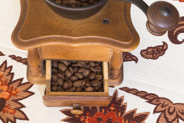 Old coffee grinder (mill) with coffee beans