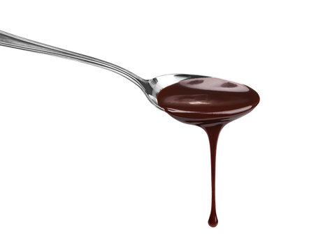 chocolate syrup leaking from spoon on white background