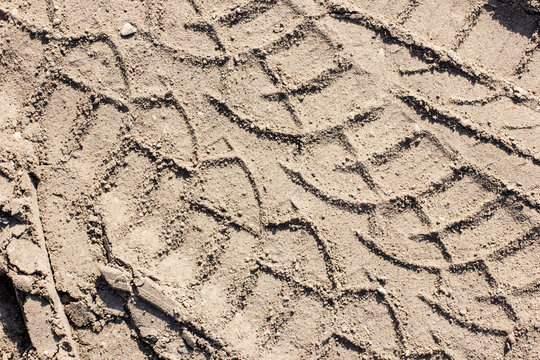 Dirty grunge tyre track on wet sand texture 