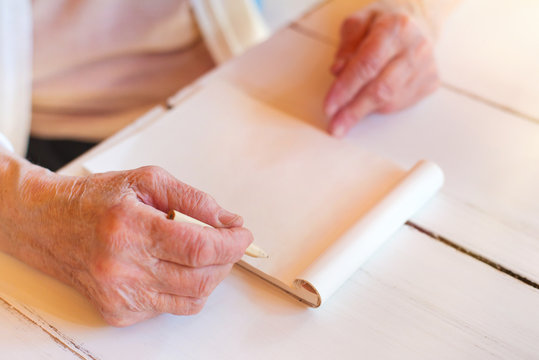 Hands Of Unrecognizable Senior Woman Writing