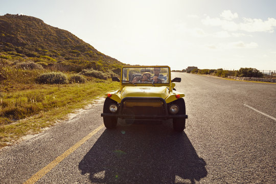 Young couple on road trip in beach buggy