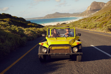 Young couple driving car in nature