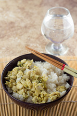 Bowl with rice and chicken and sticks