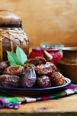 Dry dates on oriental ceramic plate with empty space