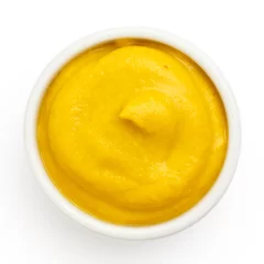 Deurstickers American yellow mustard in round dish from above on white. © Moving Moment