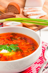 Ukrainian national red borscht with sour cream closeup