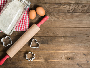Fototapeta na wymiar Flour, rolling pin, eggs and moulds