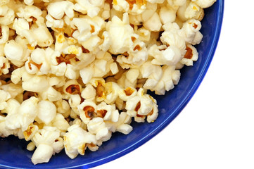 Popcorn in a blue plate isolated closeup