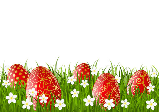 Red Easter eggs on green grass