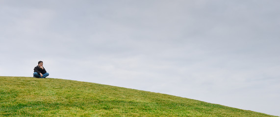 Young boy on a dune-Horizon over green grass