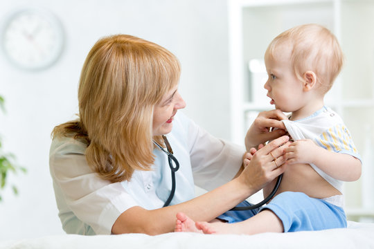 pediatrician examining heartbeat of kid with stethoscope