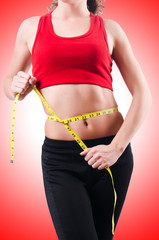 Young girl with centimeter in dieting concept