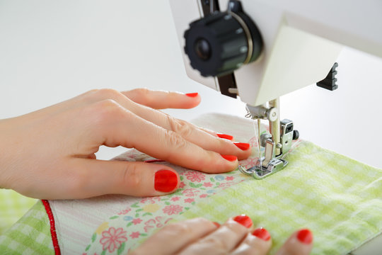 Working on sewing machine. Close look of hands and needle