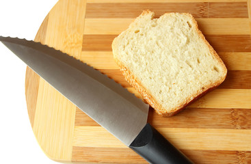 Slice of homemade bread and a knife on the board.