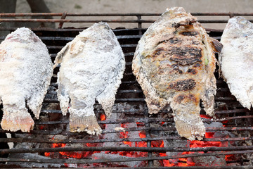 Salted fish on a charcoal grill
