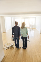Full Length Of Couple With Paint Equipment At Home