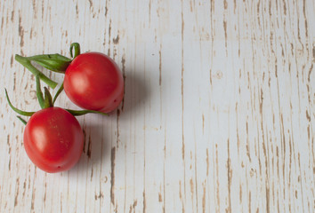 Pair of vine tomatoes on a wooden surface